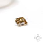 Geometric emerald cut moissanite with warm chocolate champagne hue