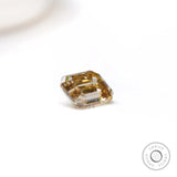 Geometric emerald cut moissanite with warm chocolate champagne hue