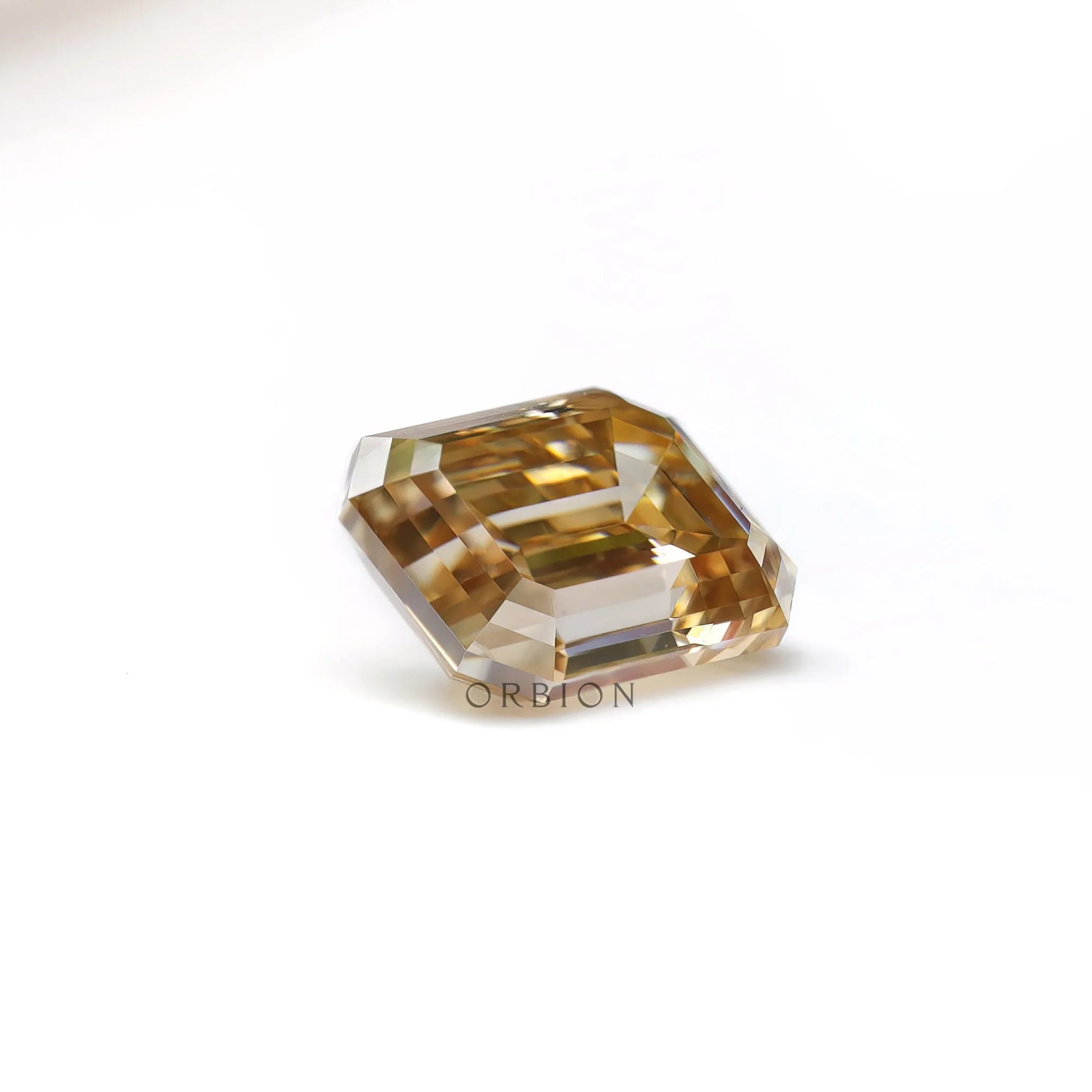 Geometric emerald cut moissanite with warm chocolate champagne hue