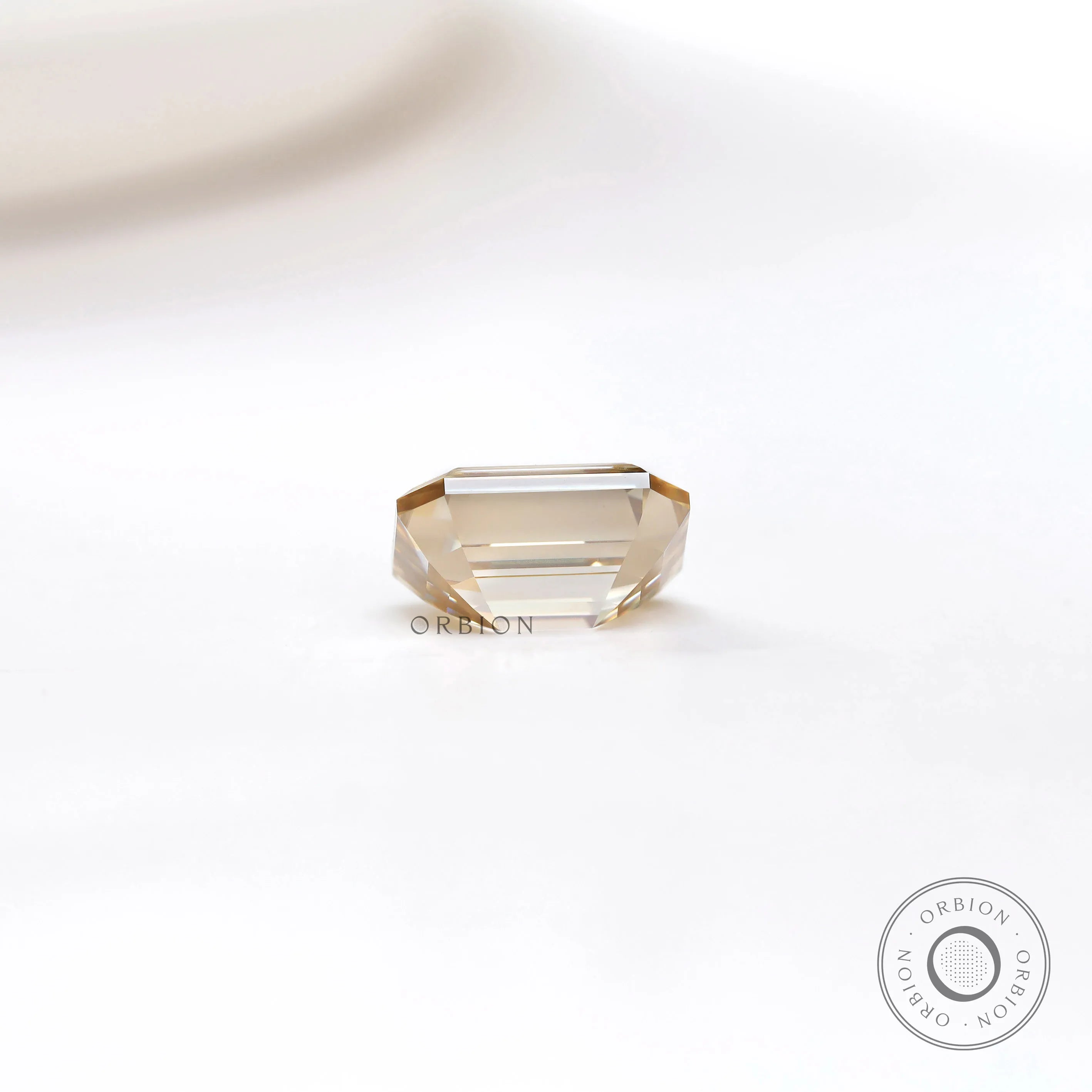 Premium loose moissanite in emerald cut with deep golden brown tone