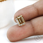 Bold statement moissanite emerald cut stone in deep warm tone