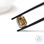 2.80 ct emerald cut dark champagne moissanite with sleek step cut facets