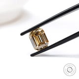 2.80 ct emerald cut dark champagne moissanite with sleek step cut facets