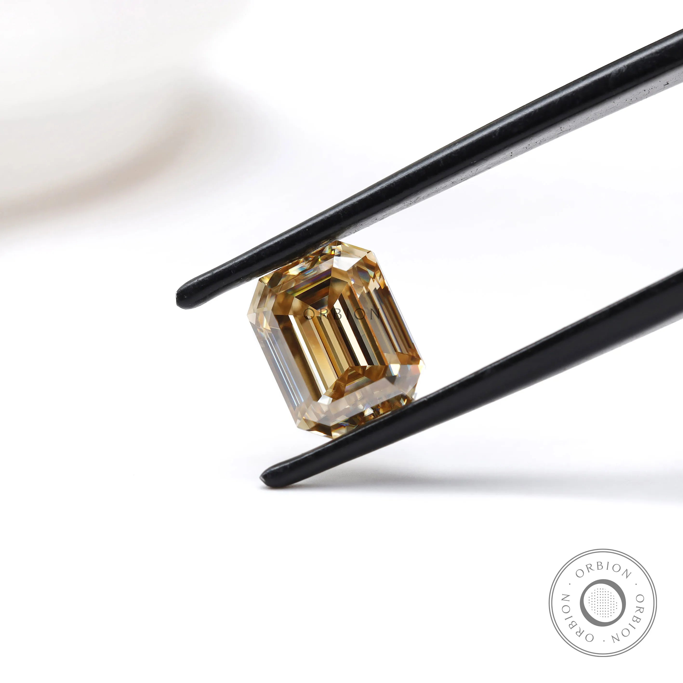 2.80 ct emerald cut dark champagne moissanite with sleek step cut facets