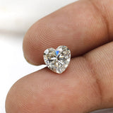 1.50 ct heart shape GHI moissanite loose stone, face up on a fingertip