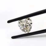 1.50 ct heart shape GHI moissanite loose stone, held in tweezers