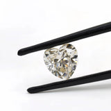 1.50 ct heart shape GHI moissanite loose stone, held in tweezers