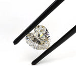 1.50 ct heart shape GHI moissanite loose stone, angled in tweezers