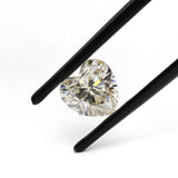 1.50 ct heart shape GHI moissanite loose stone, angled in tweezers