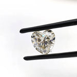 1.50 ct heart shape GHI moissanite loose stone, face up in tweezers
