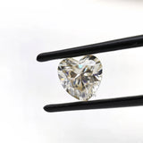 1.50 ct heart shape GHI moissanite loose stone, face up in tweezers