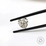 Heart shape GHI moissanite held with tweezers front view