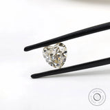 Heart shape GHI moissanite held with tweezers front view