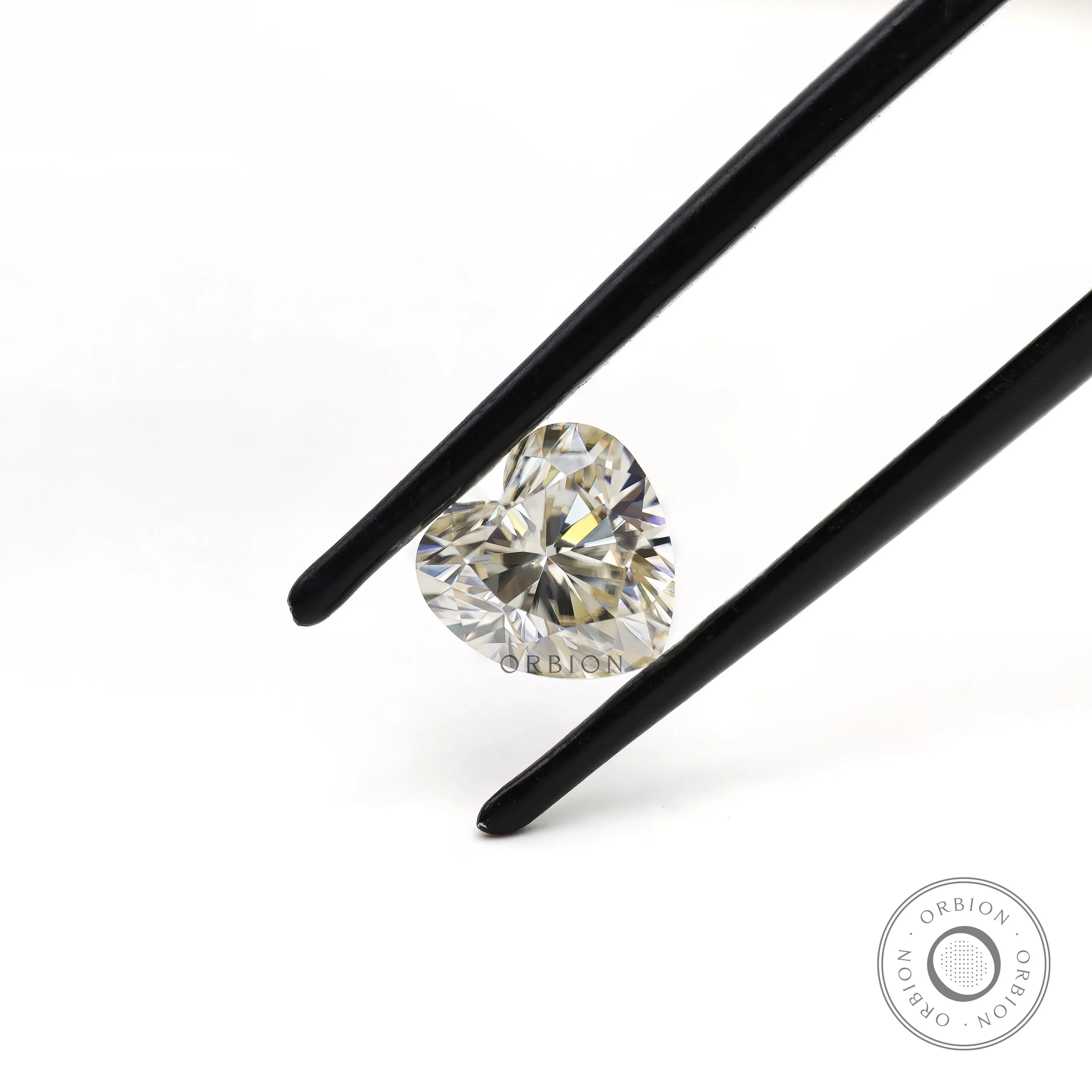 Brilliant cut heart moissanite showing facet sparkle close up
