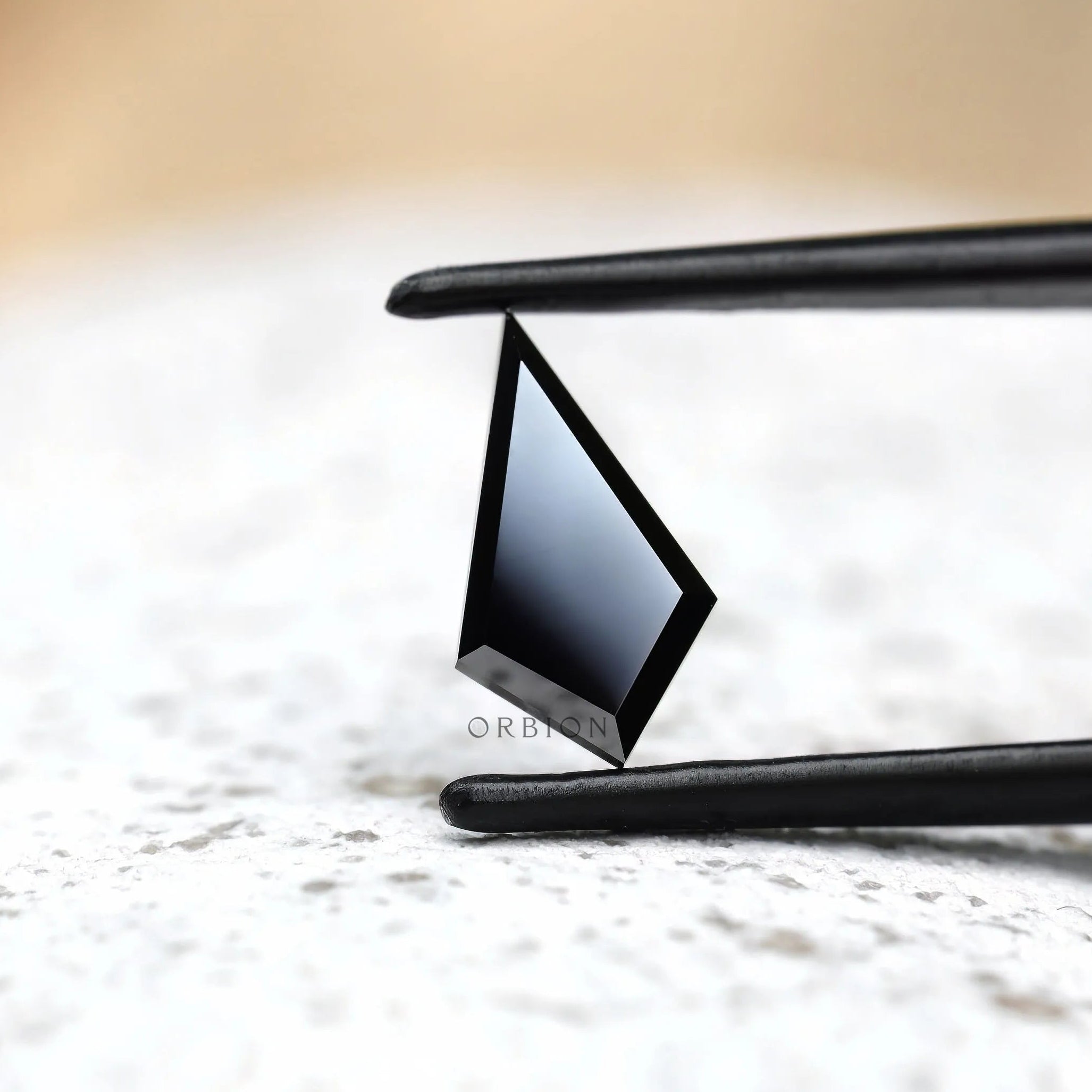 Geometric black moissanite stone step cut profile view