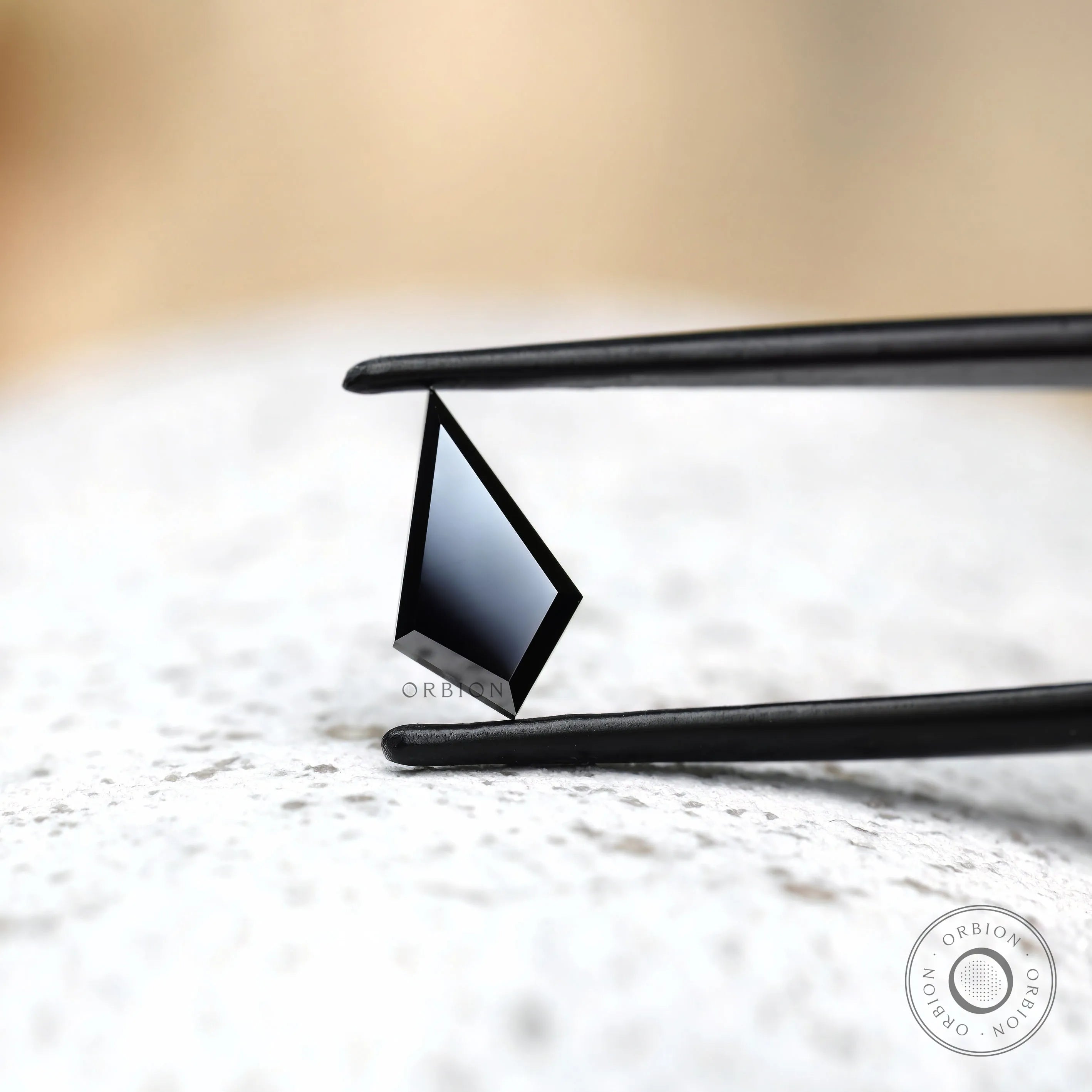 Geometric black moissanite stone step cut profile view