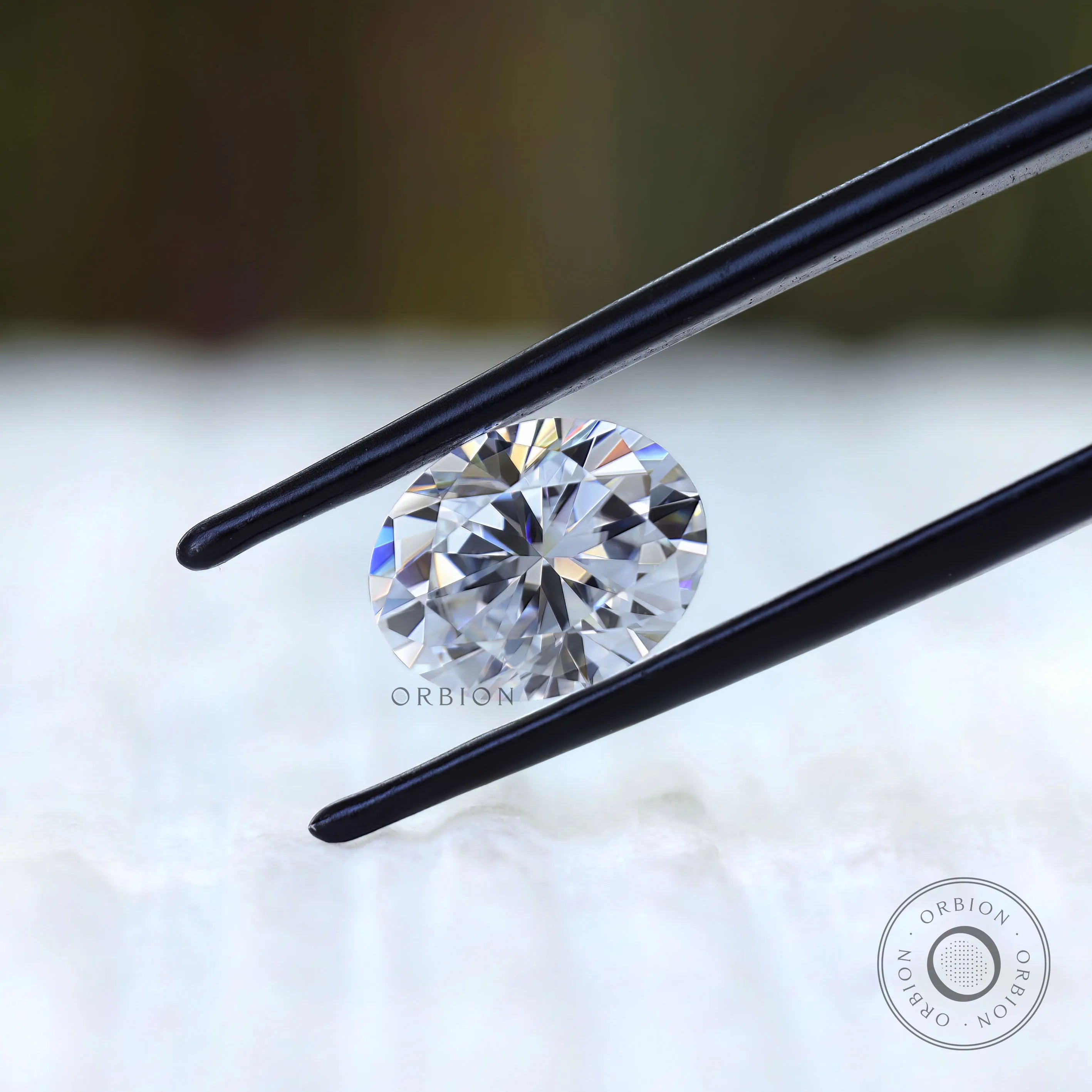 Loose oval moissanite showing hybrid cut facet pattern