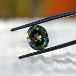 Deep green oval moissanite with vintage faceting