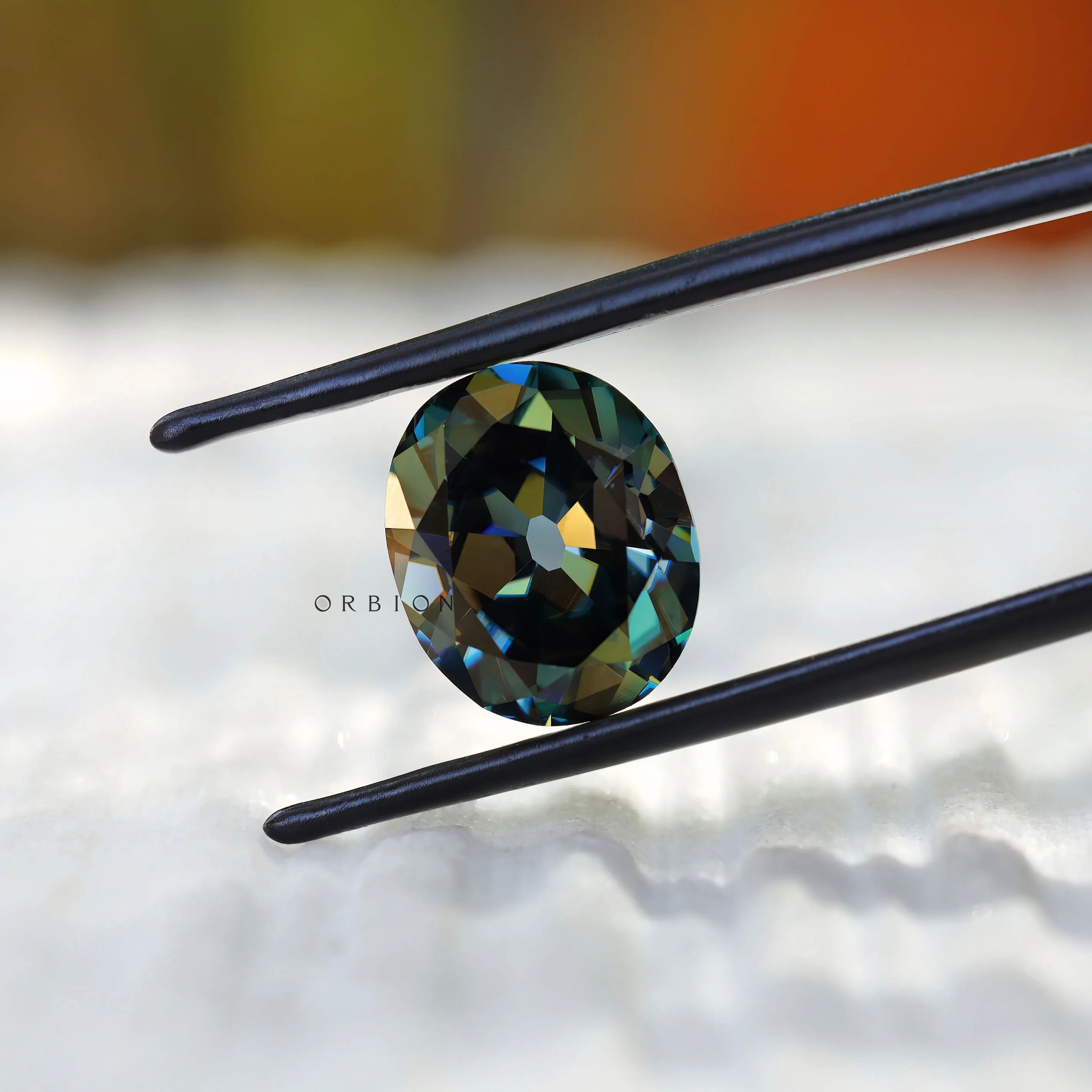 Deep green oval moissanite with vintage faceting