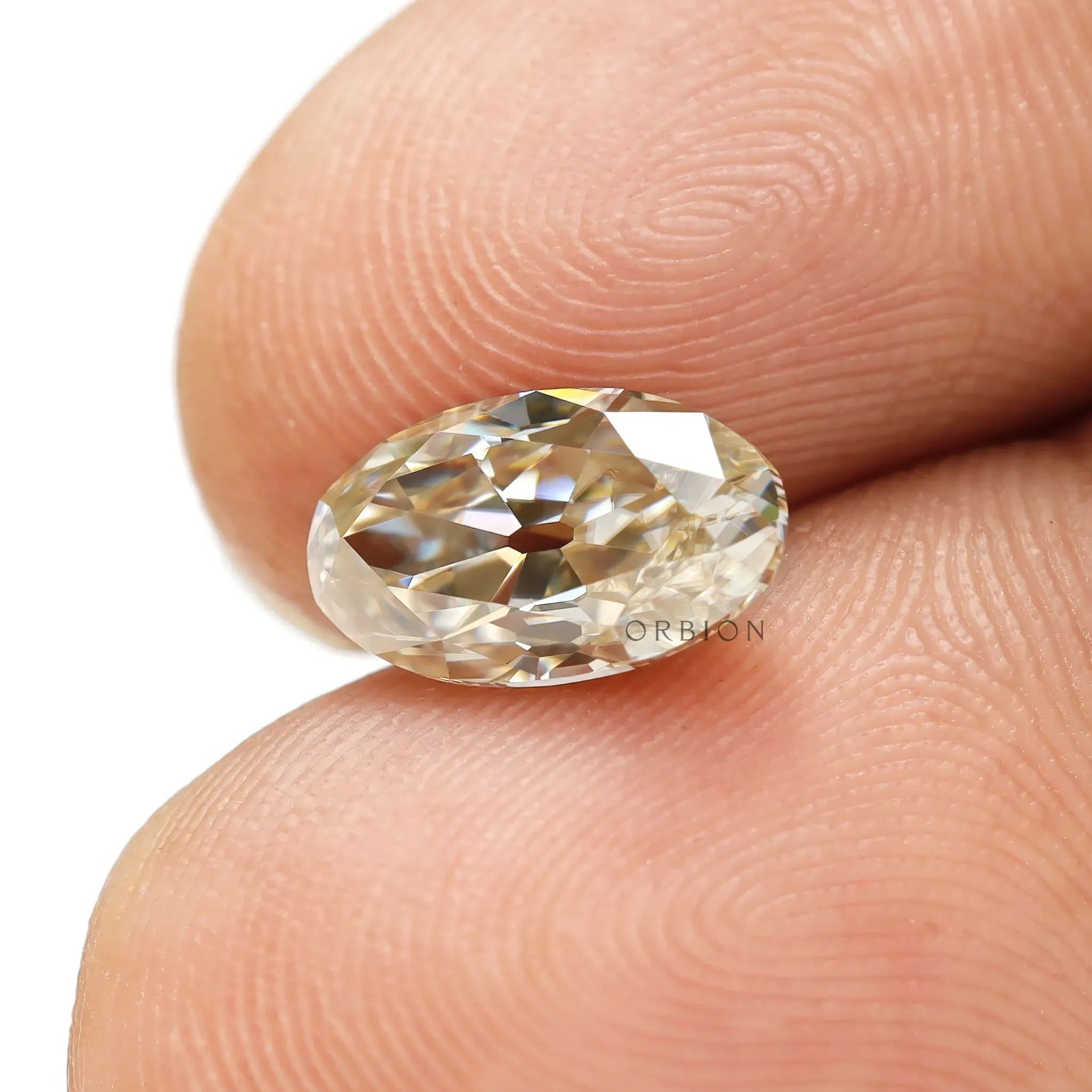 Elongated oval moissanite with warm champagne tone