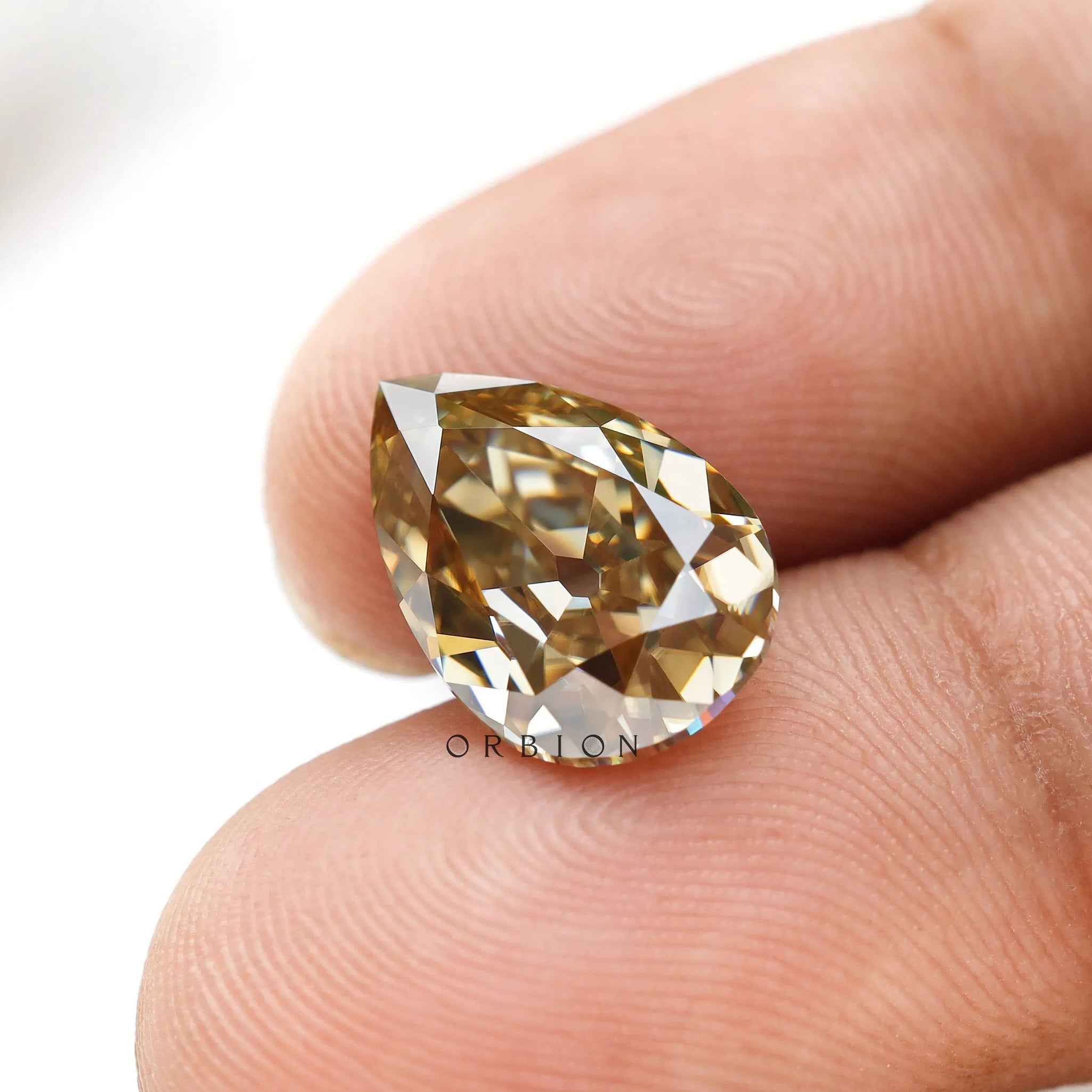 3.50 ct dark champagne moissanite pear cut with vintage brilliance
