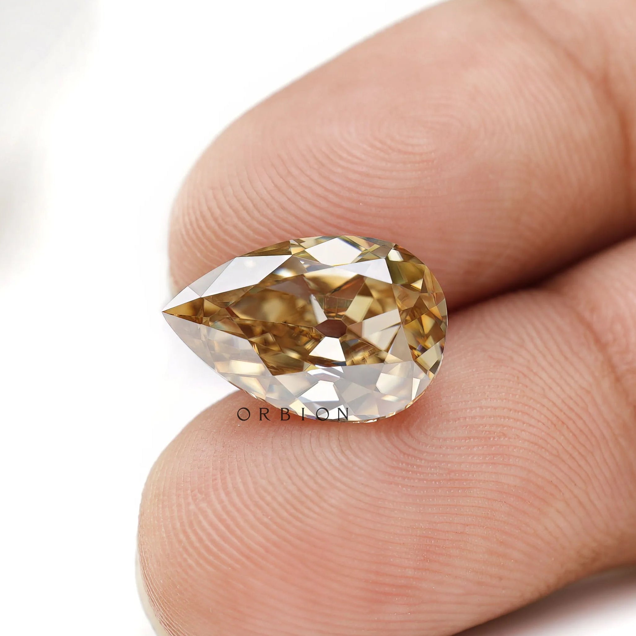 Unique pear shaped moissanite with old mine cut and deep tone