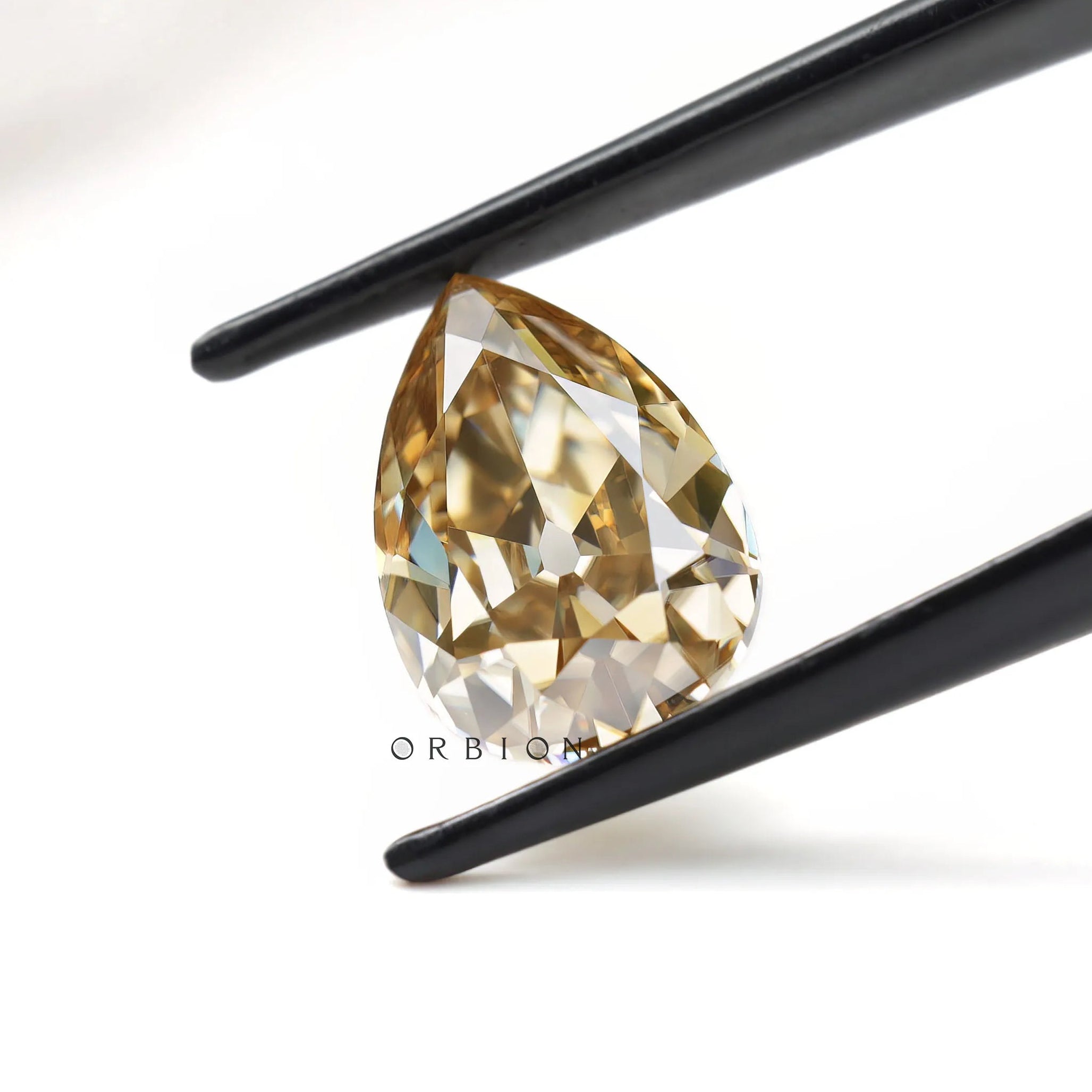 Vintage inspired pear moissanite gemstone with warm brown hue