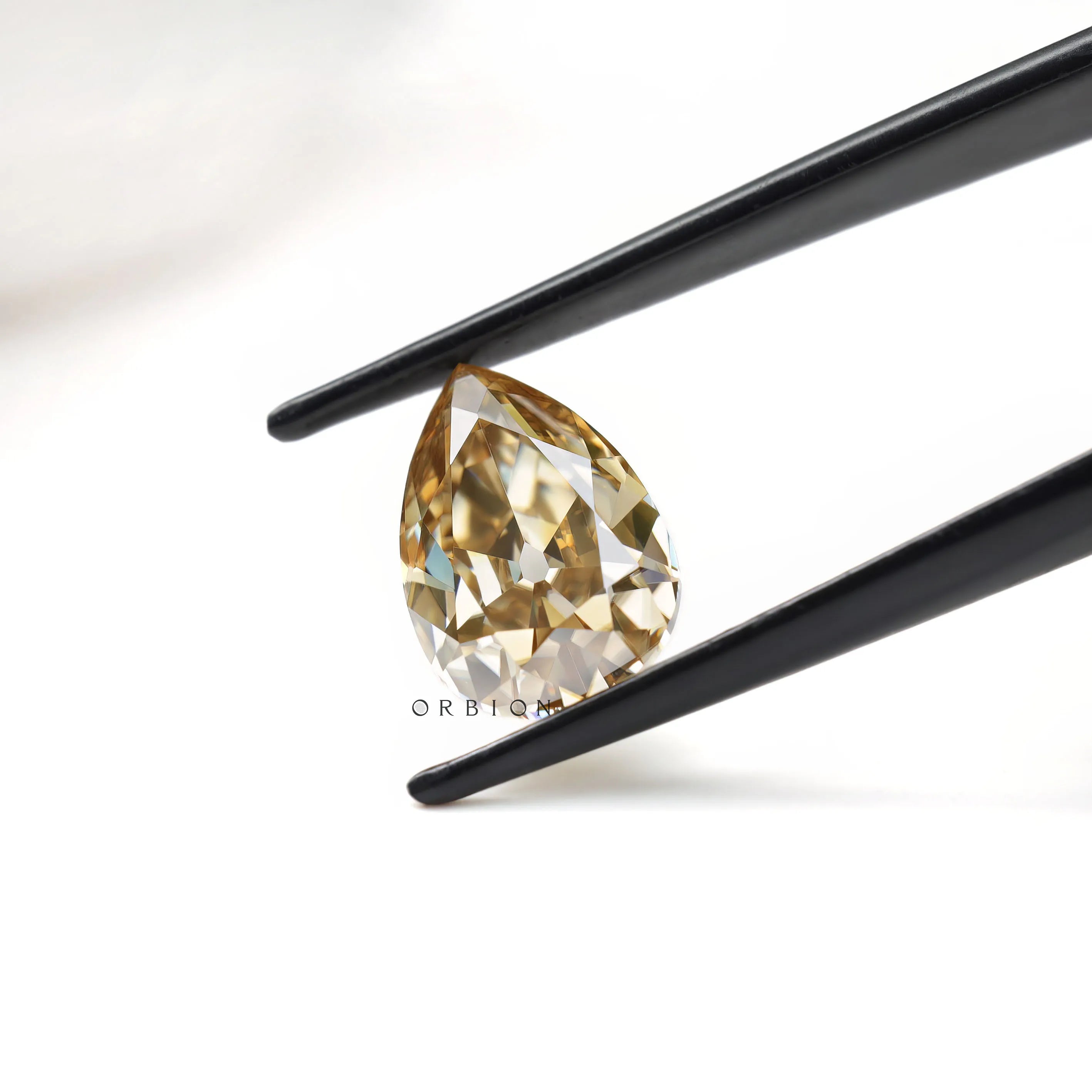 Vintage inspired pear moissanite gemstone with warm brown hue
