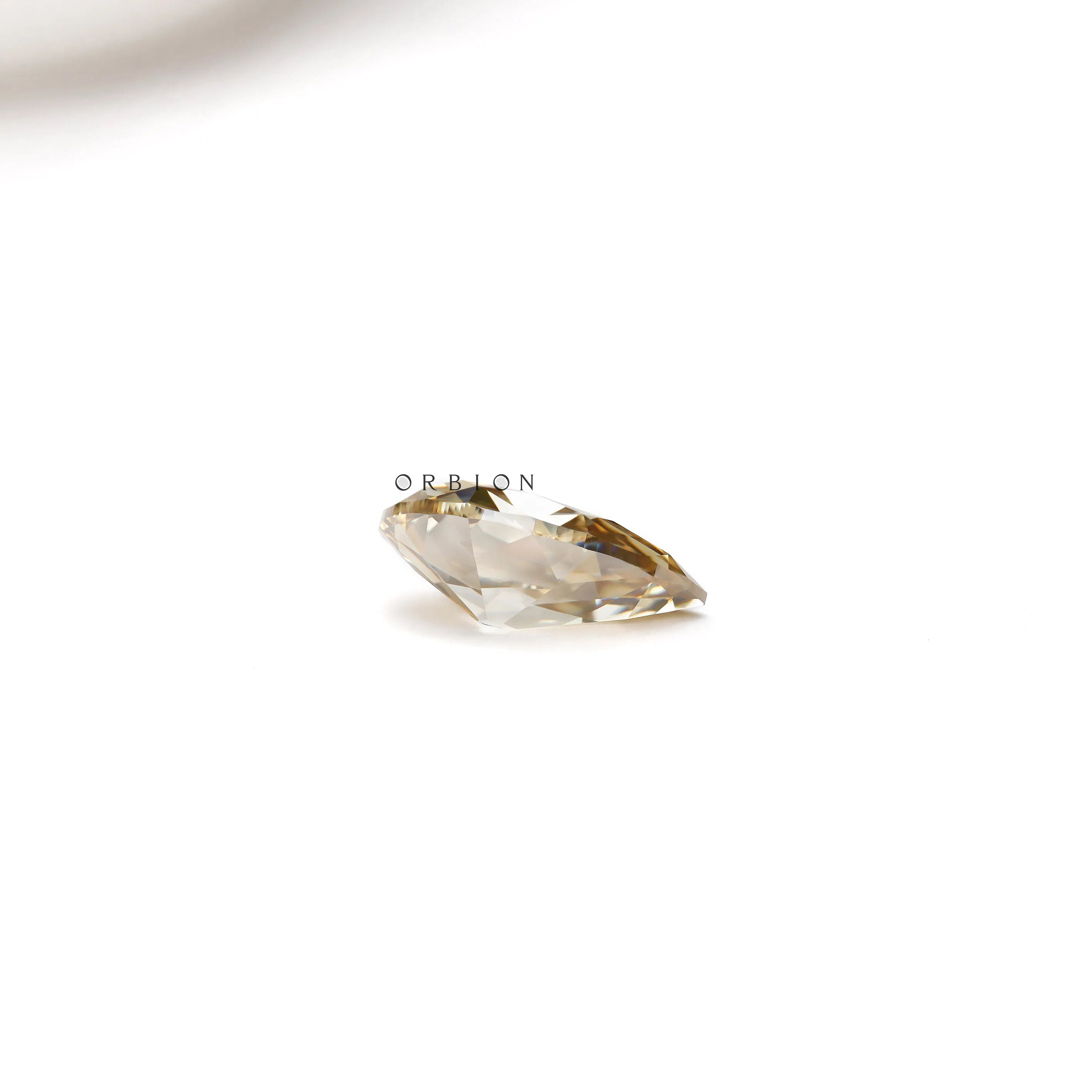 Antique cut pear moissanite stone with bold dark champagne color