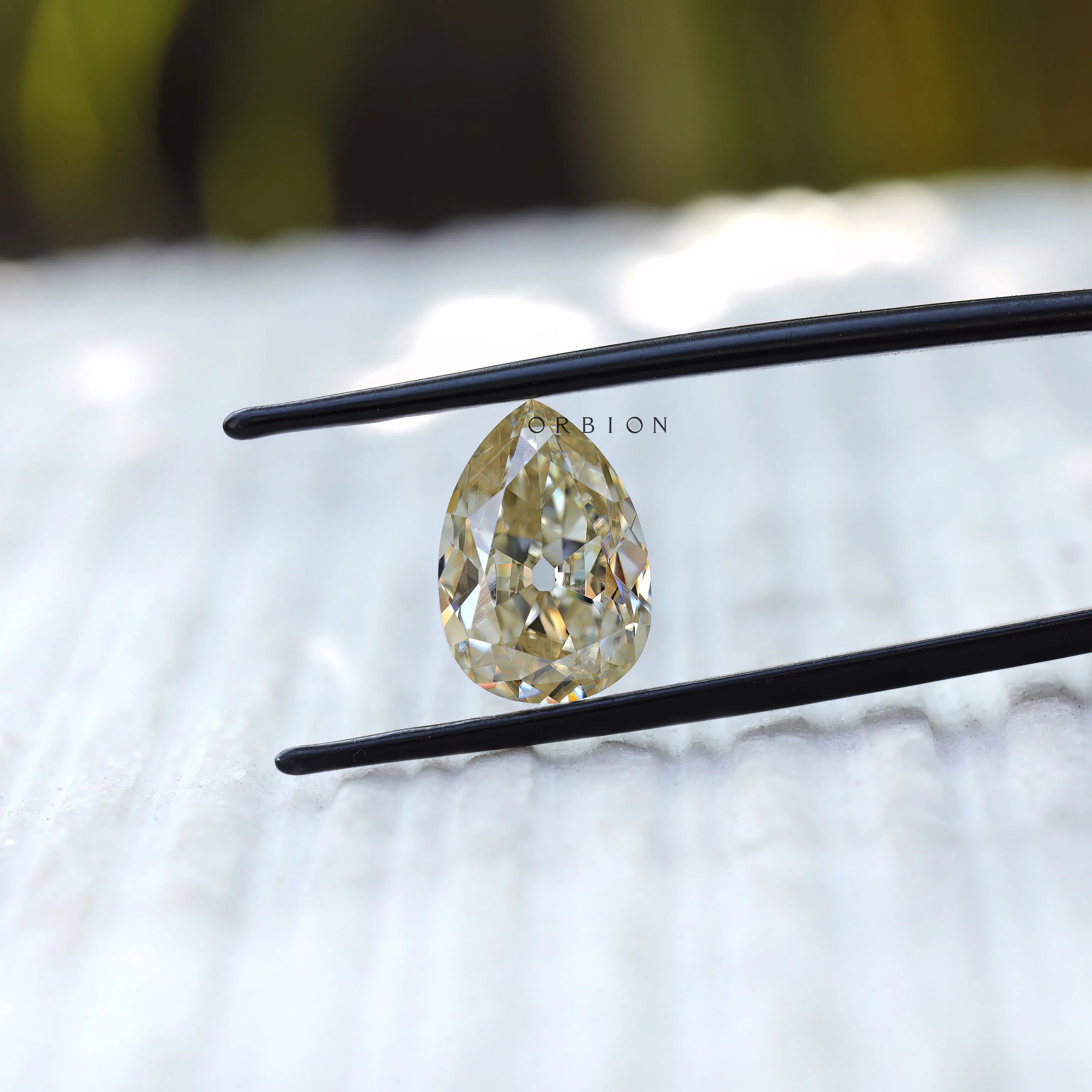 4.20 CT Pear cut moissanite in off white, old mine cut gemstone