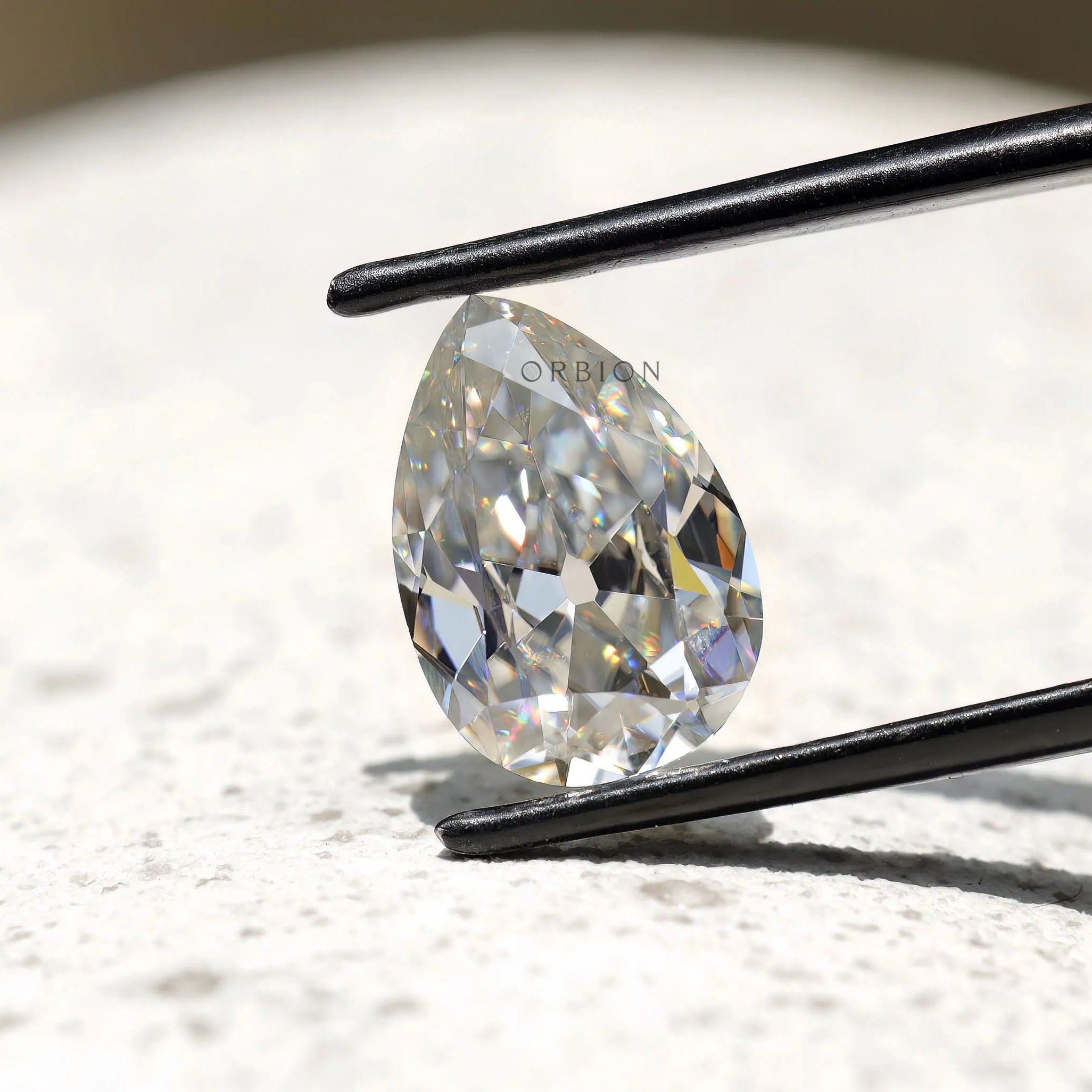 Pear shape moissanite solitaire with antique cut sparkle