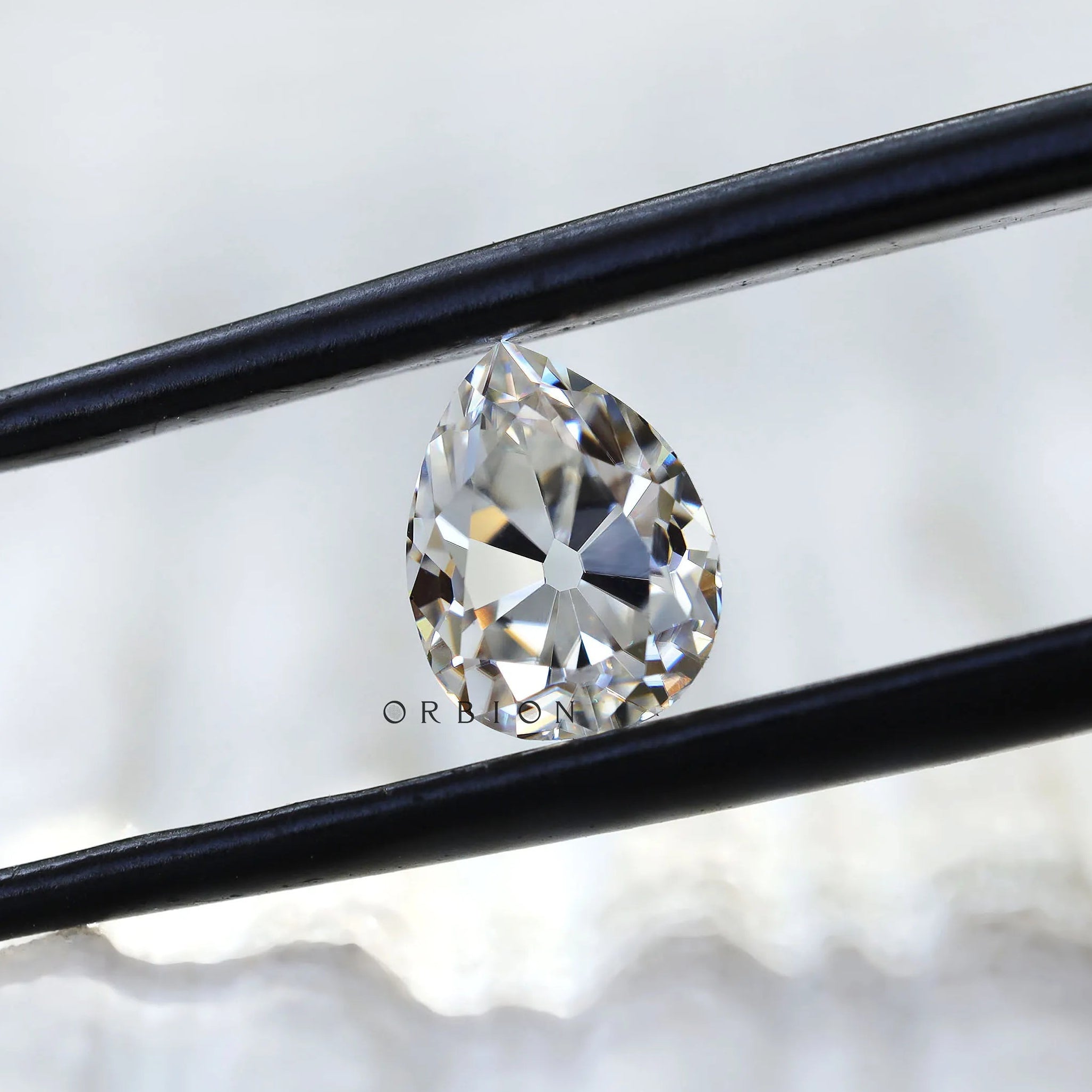 Angled view of pear moissanite showing facet brilliance