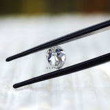 Side profile of pear moissanite on textured surface