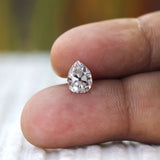 Finger scale view of pear moissanite size reference