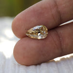 2.80 ct Pear moissanite with subtle champagne tone old mine cut