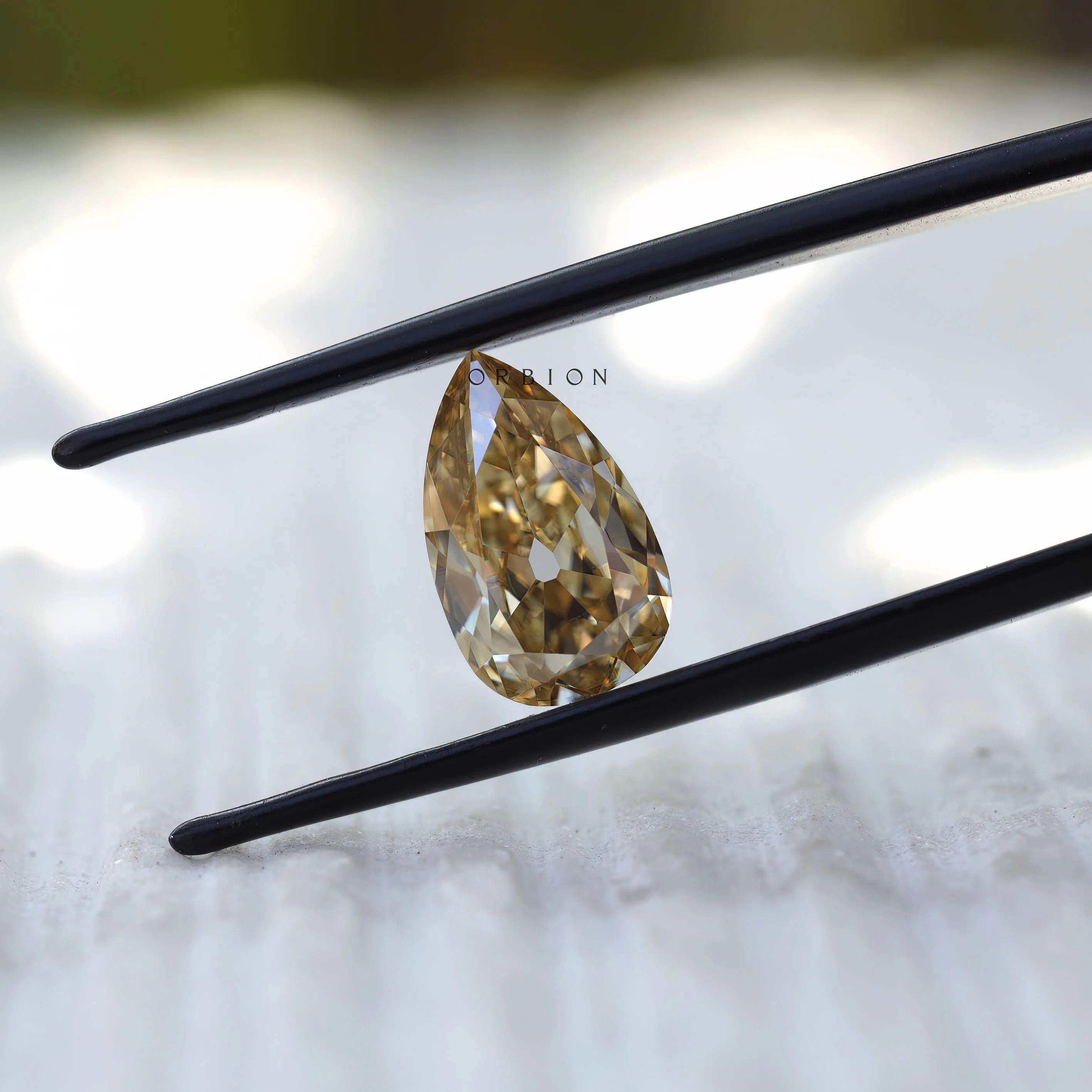 Pear shaped moissanite 2.80 ct in pale champagne tone antique faceting