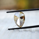 Pear moissanite facet reflection macro shot