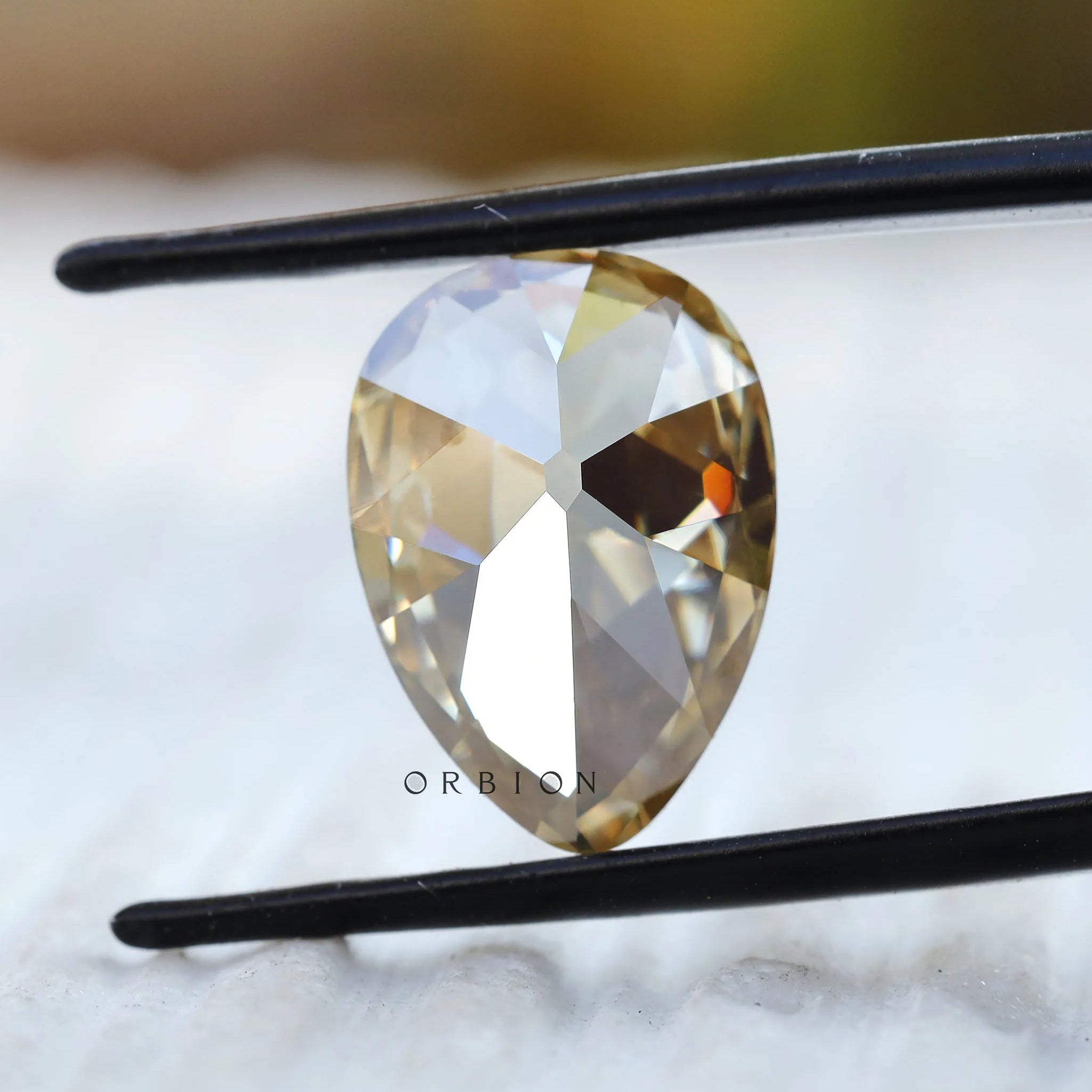 Pear moissanite facet reflection macro shot