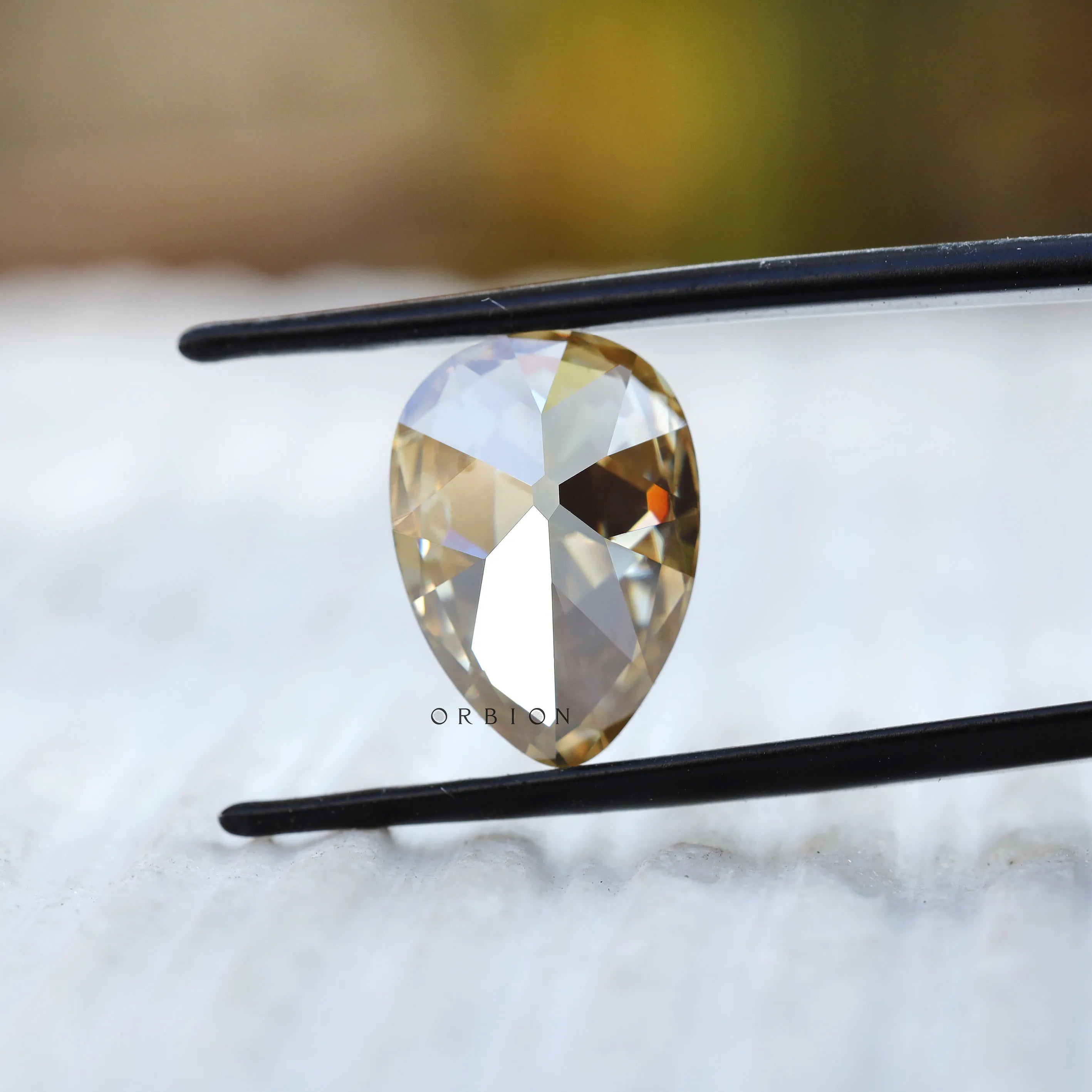 Pear moissanite facet reflection macro shot