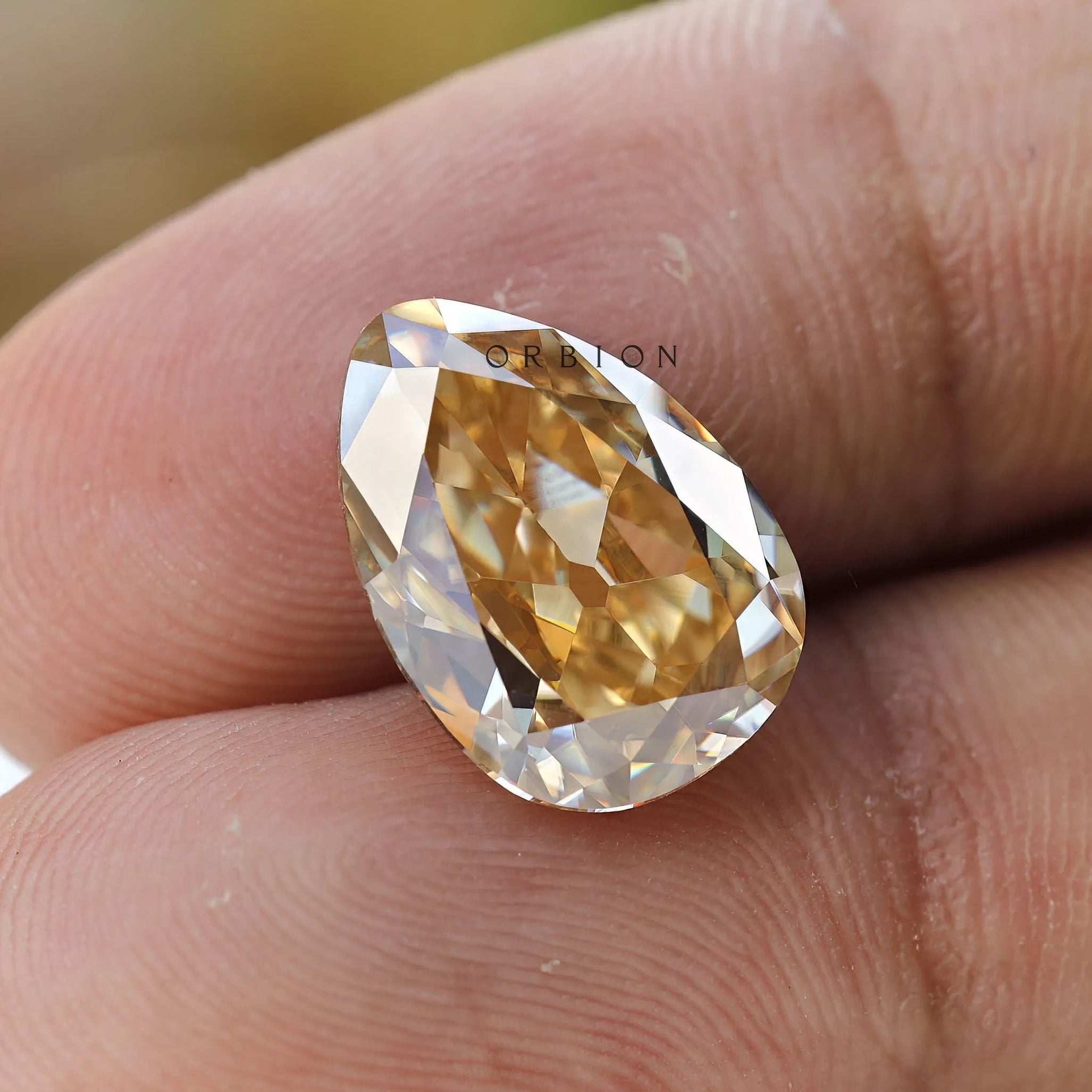 Yellow moissanite pear gemstone finger scale view