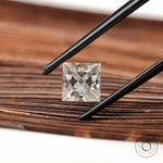 Loose princess moissanite stone on wooden background