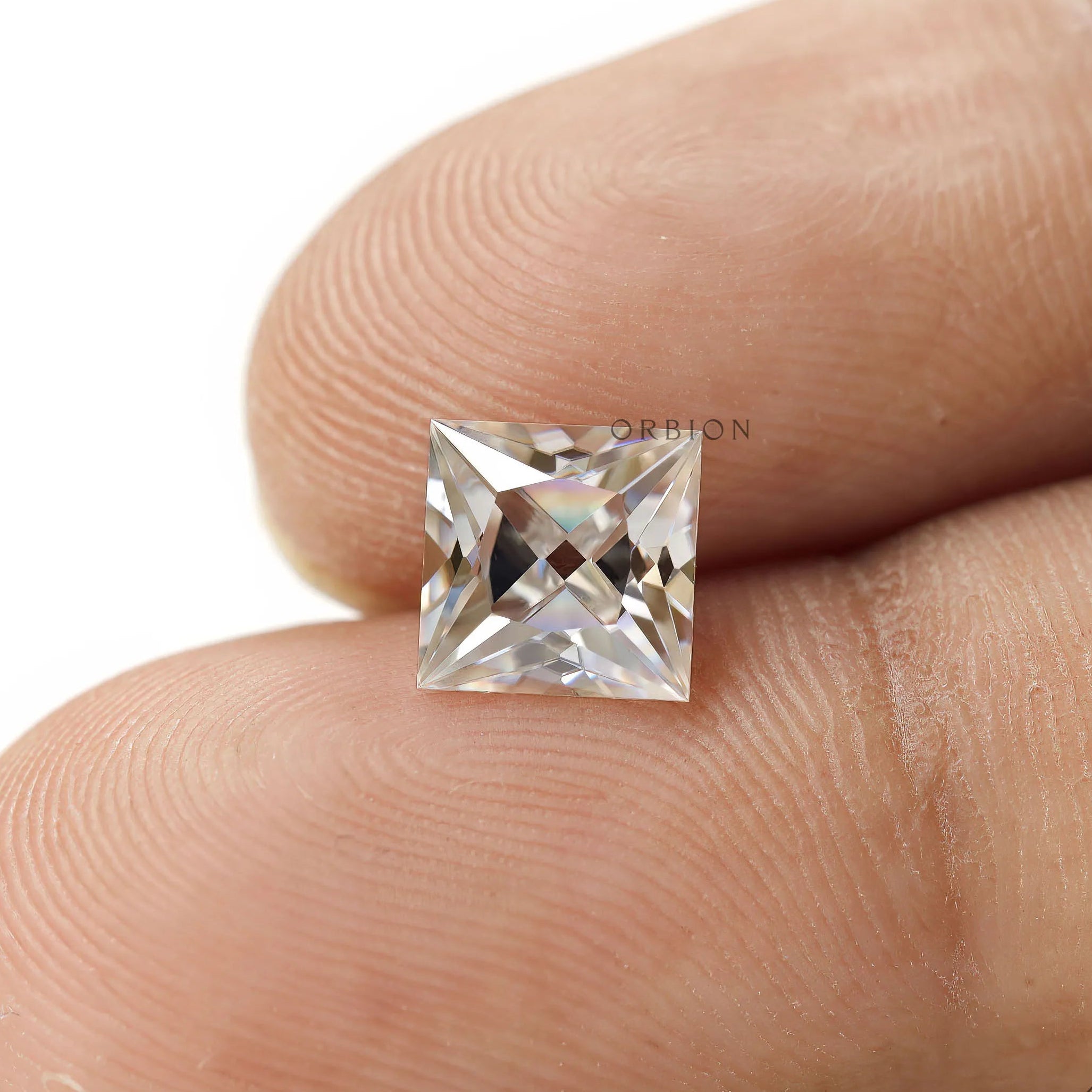 Close up finger hold princess moissanite stone square shape