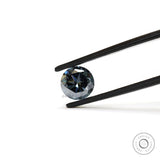 Dark grey round moissanite gemstone held in tweezers with sharp brilliant facets