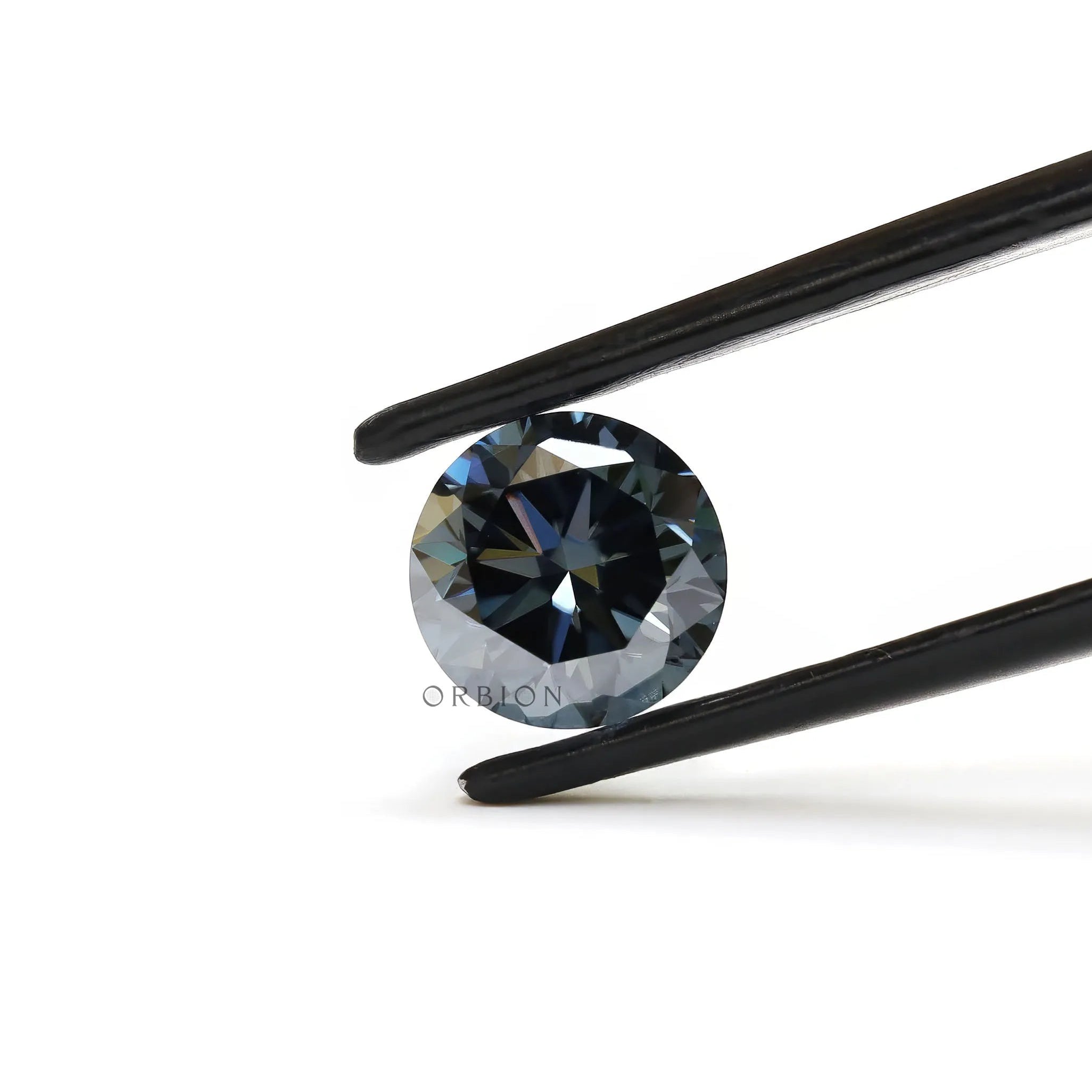 Dark grey round moissanite gemstone held in tweezers with sharp brilliant facets