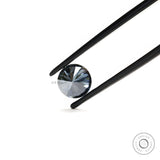 Close up of round dark grey moissanite with deep reflective brilliance