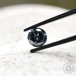 Dark grey moissanite round stone showing contrast of light and shadow
