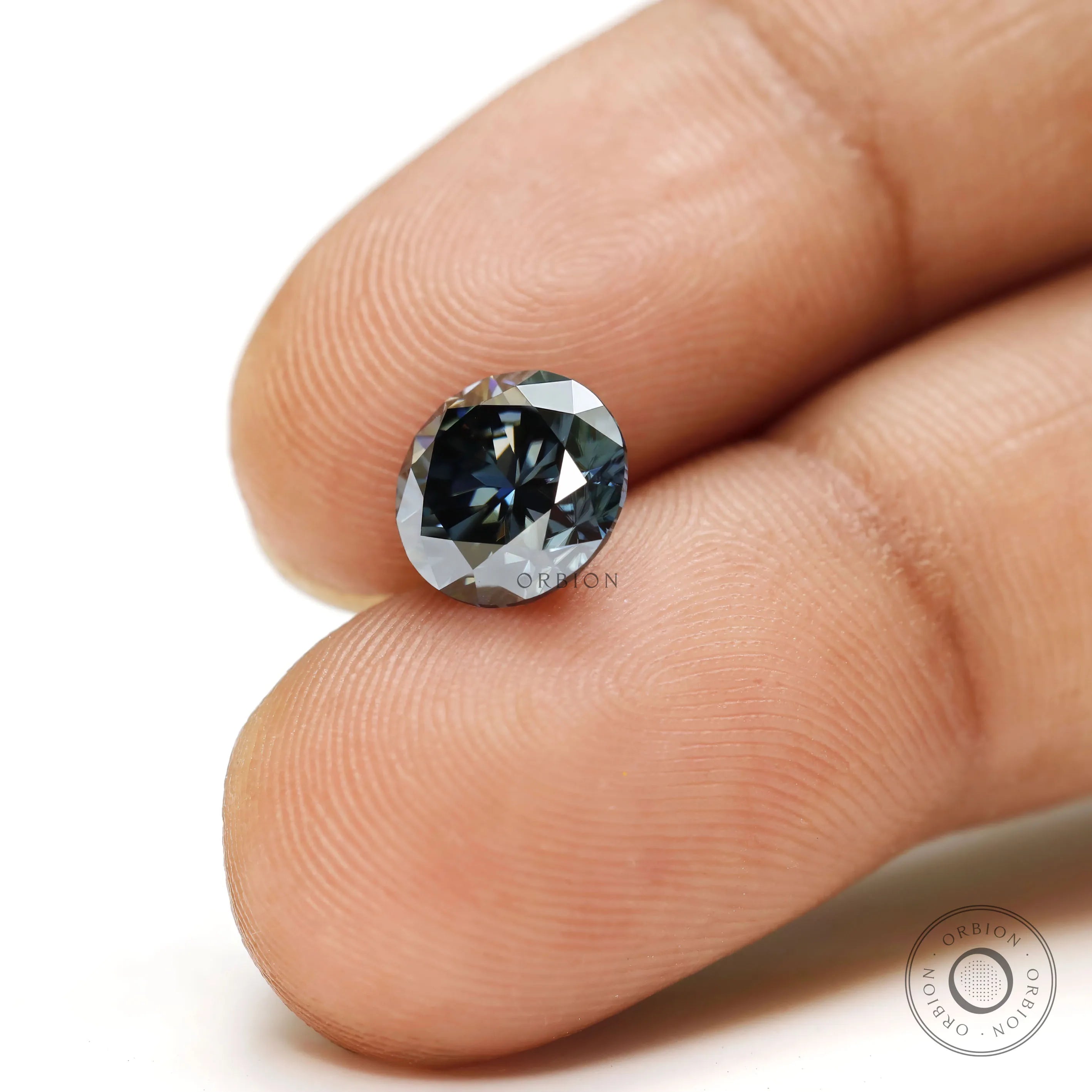 Detailed view of dark grey moissanite round stone with symmetrical facets