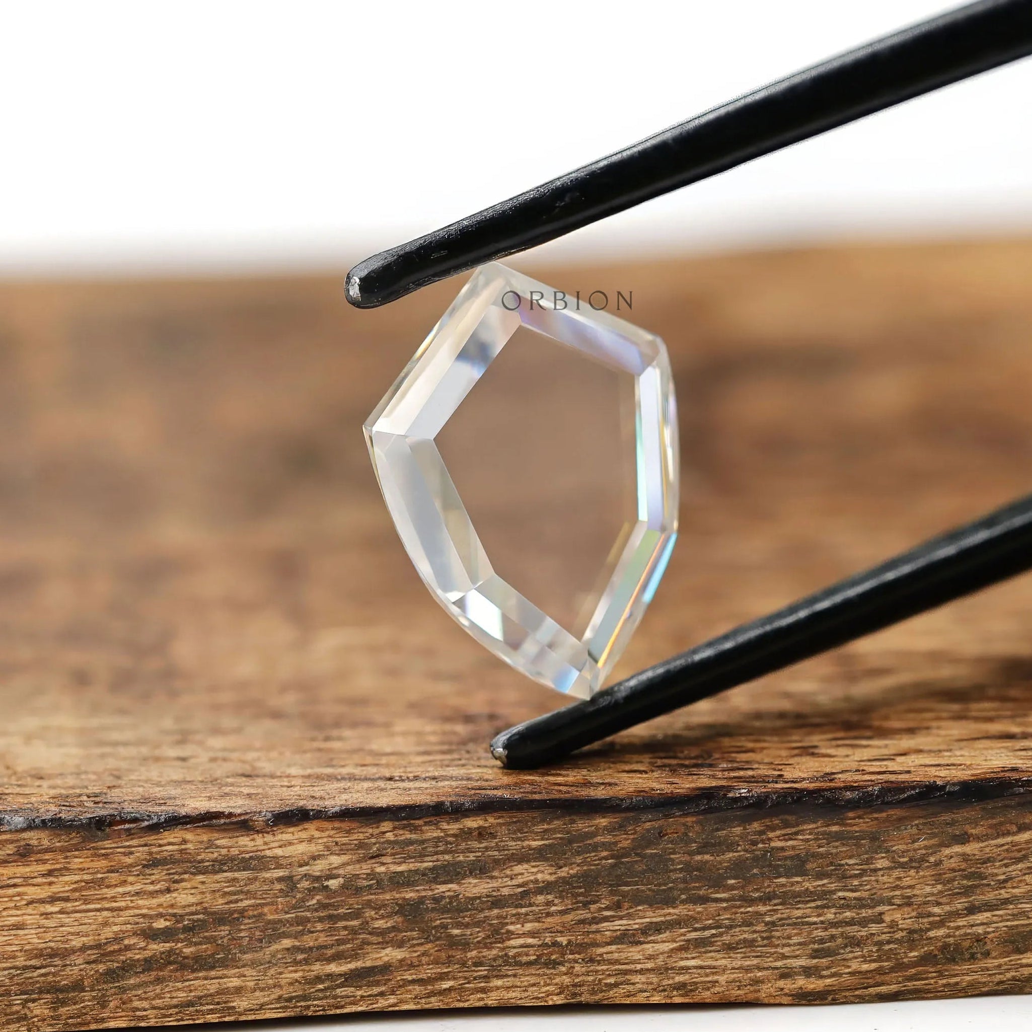 Colorless moissanite shield shape portrait cut stone