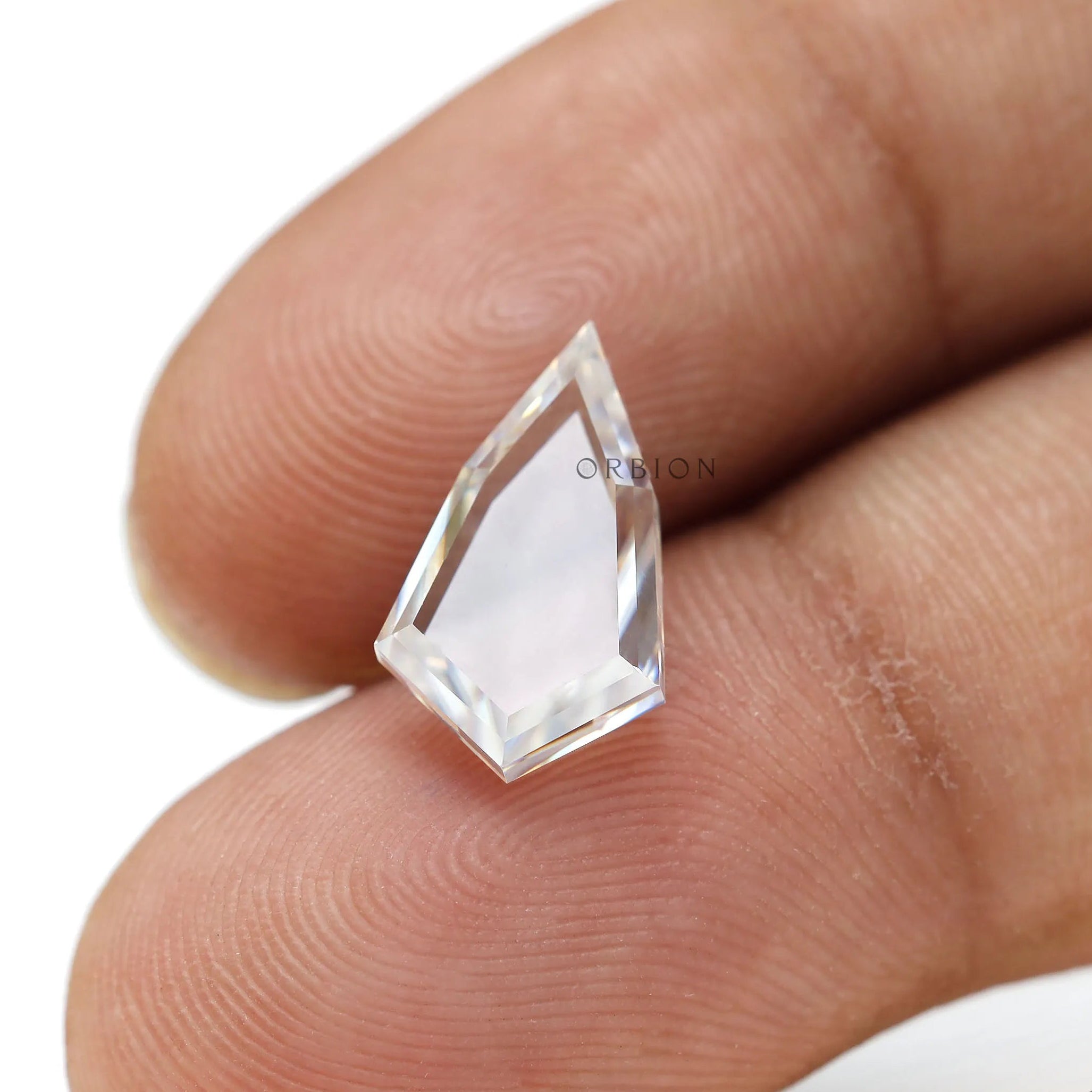 Transparent portrait cut moissanite on fingertip