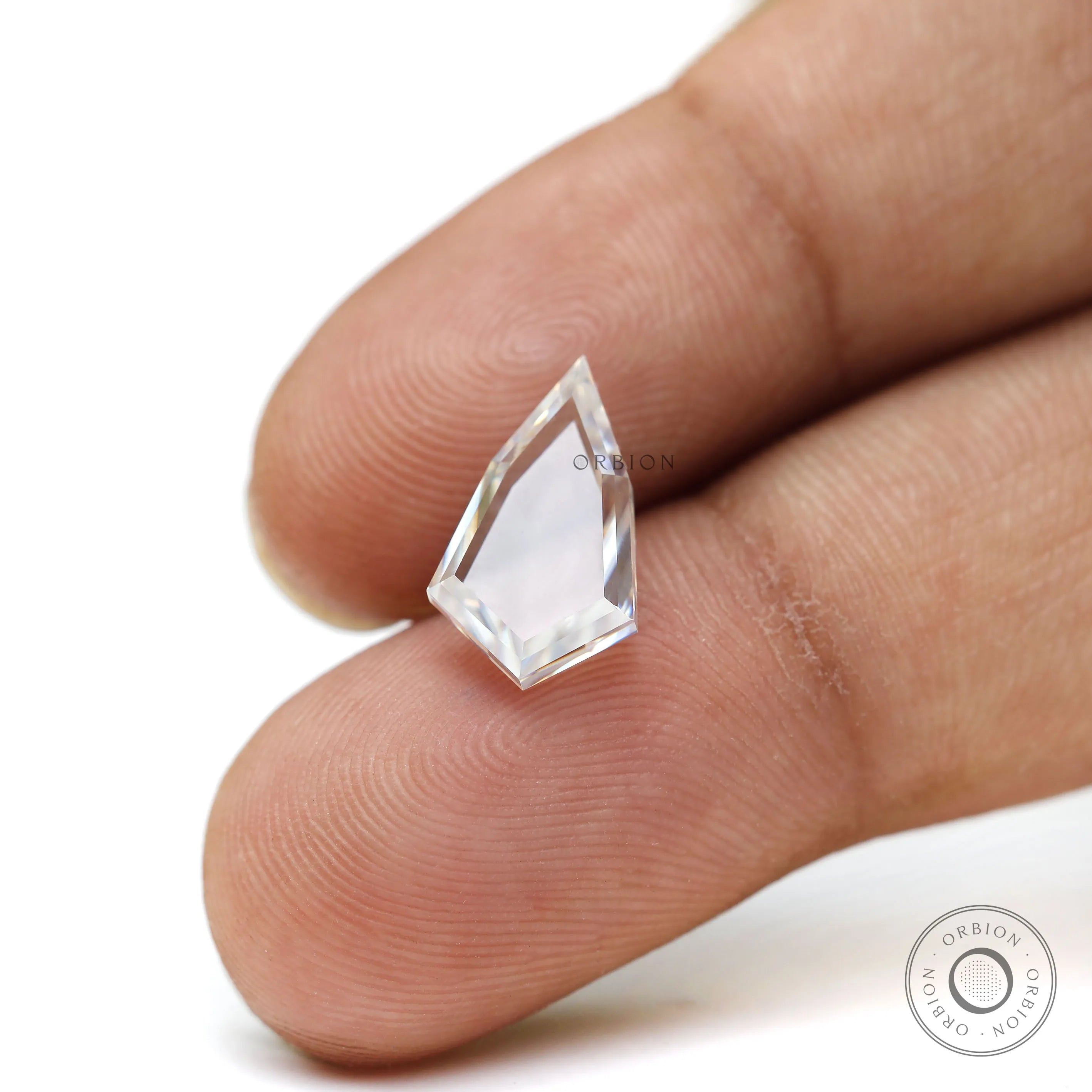 Transparent portrait cut moissanite on fingertip